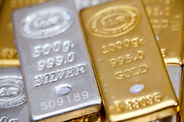 Gold dips as dollar gains, traders dial back US rate-cut bets